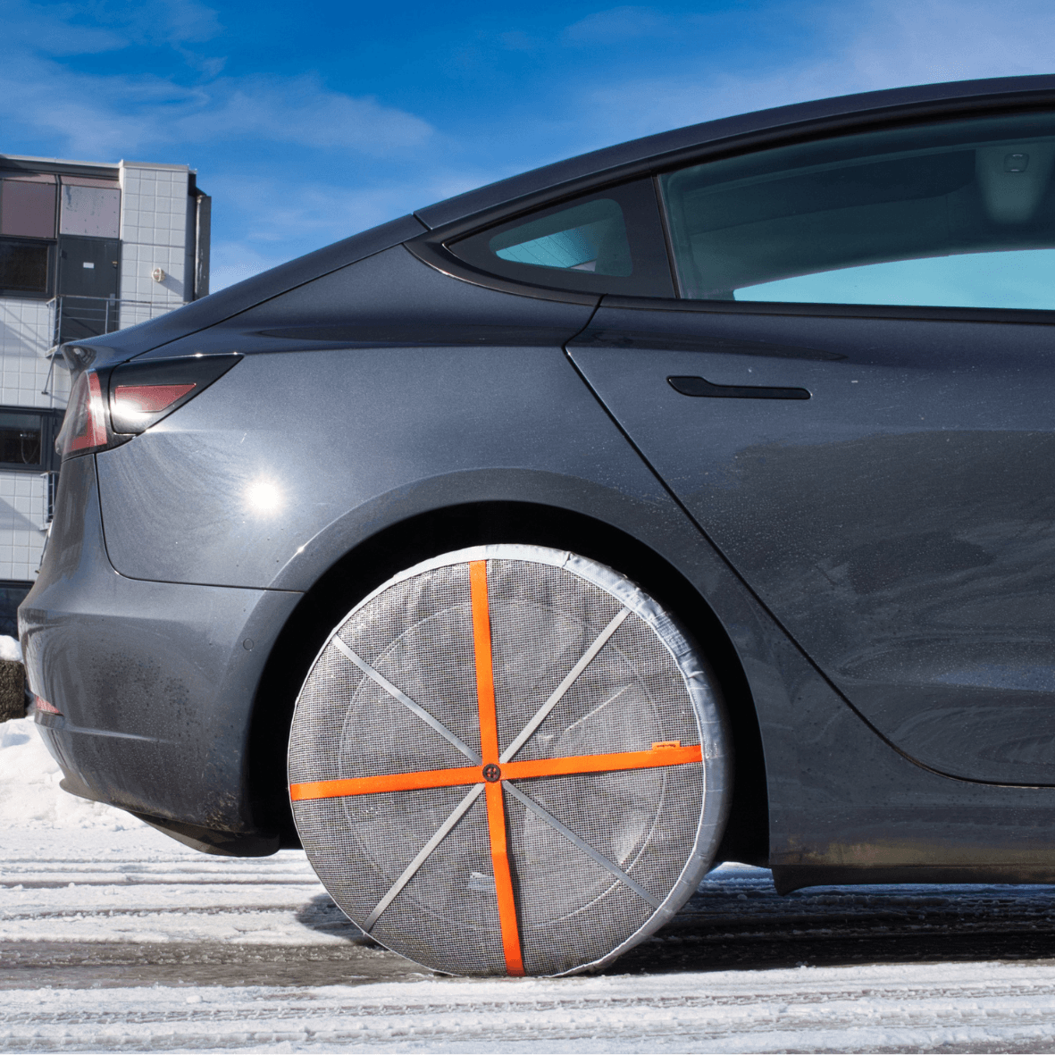 AutoSock HP for passenger cars mounted on rear wheels of a car on snow