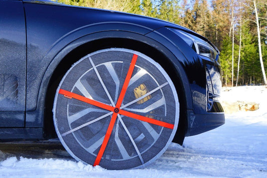 AutoSock mounted on a winter tire, driving on snow