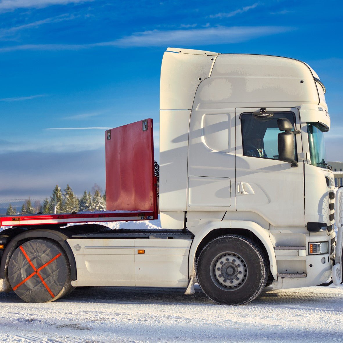 AutoSock for trucks AL installed on rear wheels of a truck, standing on snow