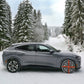 Passenger car with AutoSock HP-series mounted, standing on snow in winter landscape